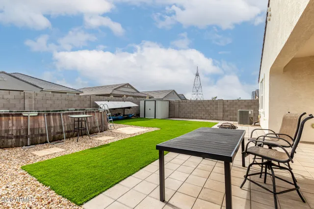 a front view of house with a garden and patio