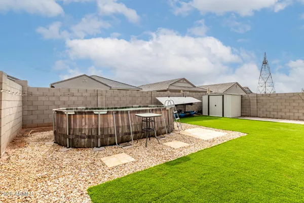 a view of a house with swimming pool and sitting area