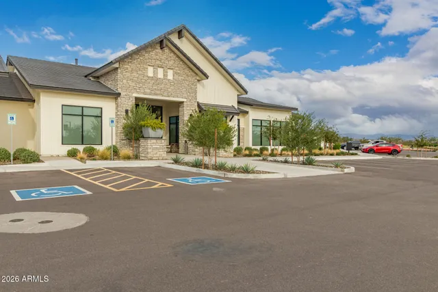 a kitchen with kitchen island granite countertop a table chairs stove and a sink