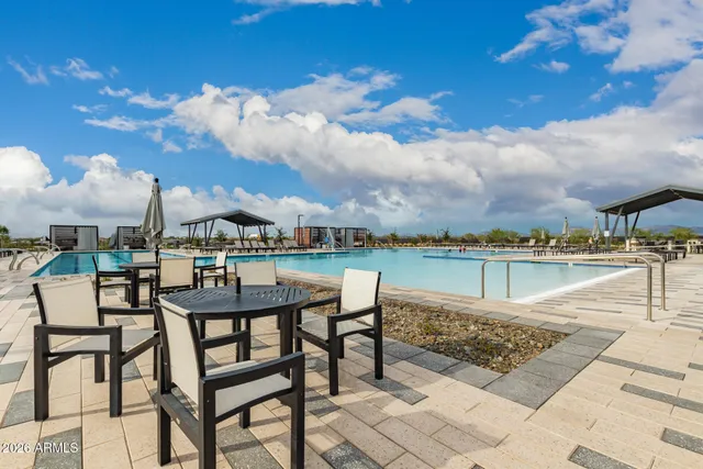 a view of a house with a yard and potted plants