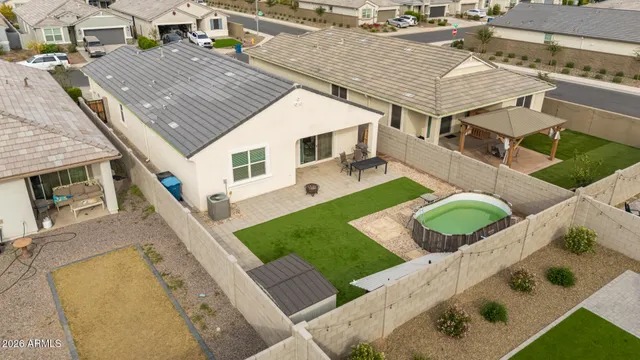 a front view of a house with a yard and potted plants