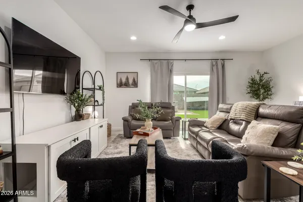 a kitchen with stainless steel appliances granite countertop a table and chairs in it