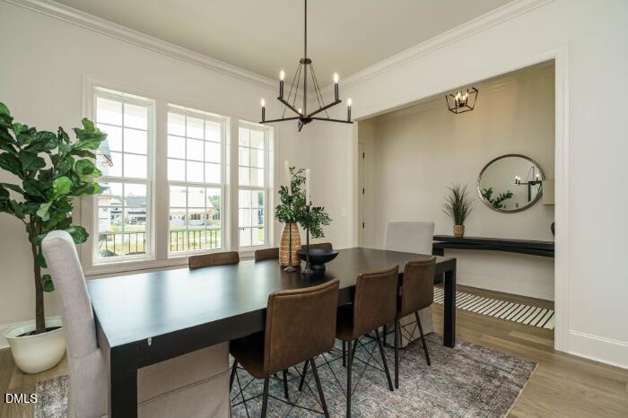 755 West Holly Springs Road Holly Springs, NC 27540 - Photo 12 of 45 a view of a dining room with furniture window and wooden floor