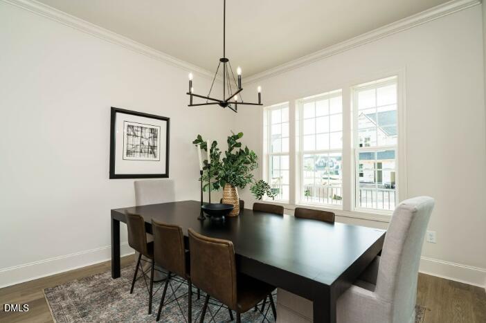 755 West Holly Springs Road Holly Springs, NC 27540 - Photo 19 of 45 a view of a dining room with furniture window and wooden floor