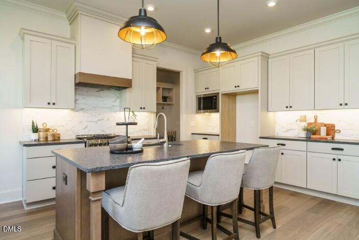 755 West Holly Springs Road Holly Springs, NC 27540 - Photo 20 of 45 a kitchen with cabinets table and chairs