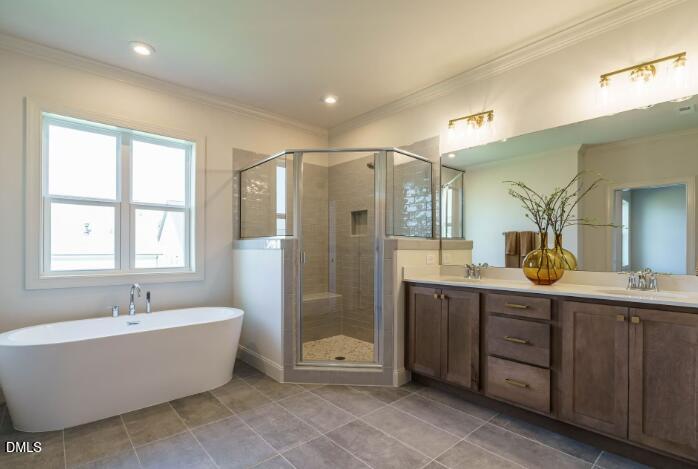 755 West Holly Springs Road Holly Springs, NC 27540 - Photo 25 of 45 a bathroom with a tub a double vanity sink a shower and a mirror
