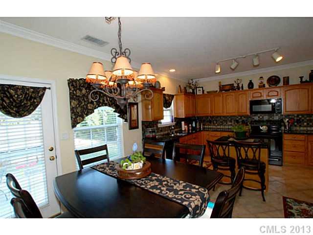 2005 Brook Valley Run Monroe, NC 28110 - Photo 6 of 15 a view of a dining room with furniture and chandelier