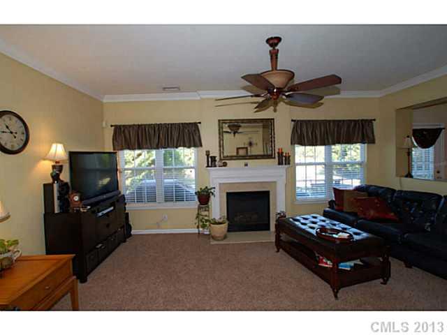 2005 Brook Valley Run Monroe, NC 28110 - Photo 7 of 15 a living room with furniture a fireplace and a flat screen tv