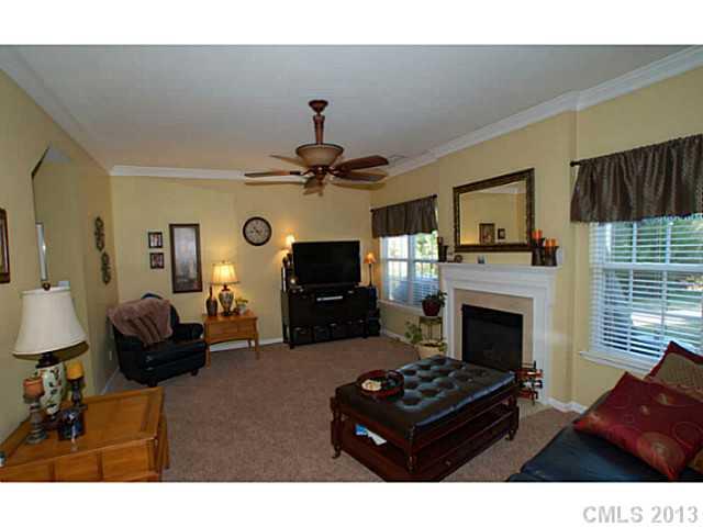 2005 Brook Valley Run Monroe, NC 28110 - Photo 8 of 15 a living room with furniture a flat screen tv and a fireplace