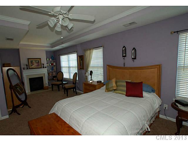2005 Brook Valley Run Monroe, NC 28110 - Photo 9 of 15 a bedroom with a bed a table and chair