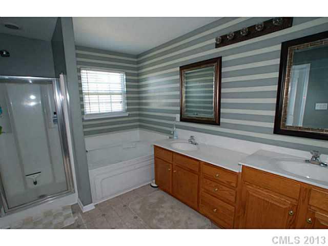 2005 Brook Valley Run Monroe, NC 28110 - Photo 10 of 15 a bathroom with a sink and a large mirror