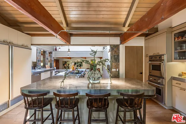 a living room with furniture a flat screen tv and a large window