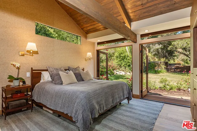 a bedroom with a large bed and a large window