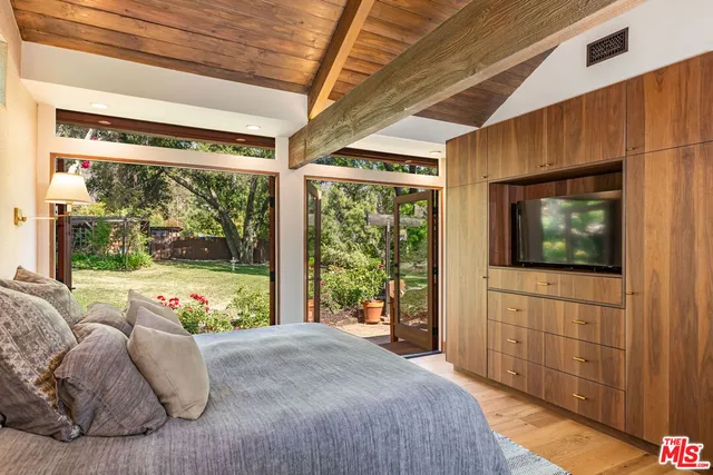 a bath tub sitting next to a bathroom sink and a mirror