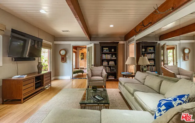 a kitchen with furniture a refrigerator and a stove top oven