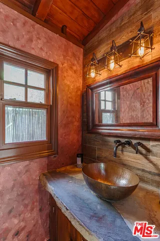 a view of a patio with table and chairs under an umbrella