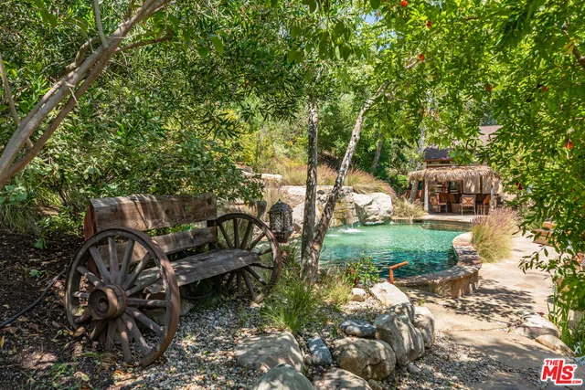 a view of a bench in backyard of a house