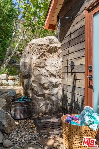 a view of a patio with a table chairs and a small yard