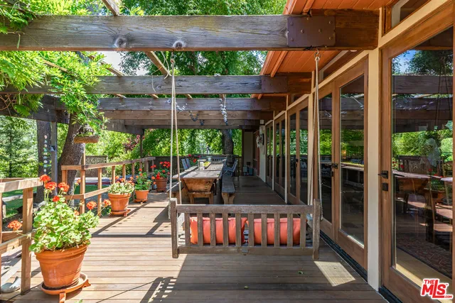 an aerial view of a houses with a lush green hillside