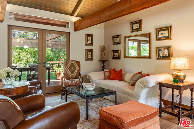 a dining room with furniture wooden floor and a potted plant