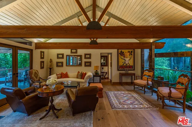 a dining room with furniture window and wooden floor