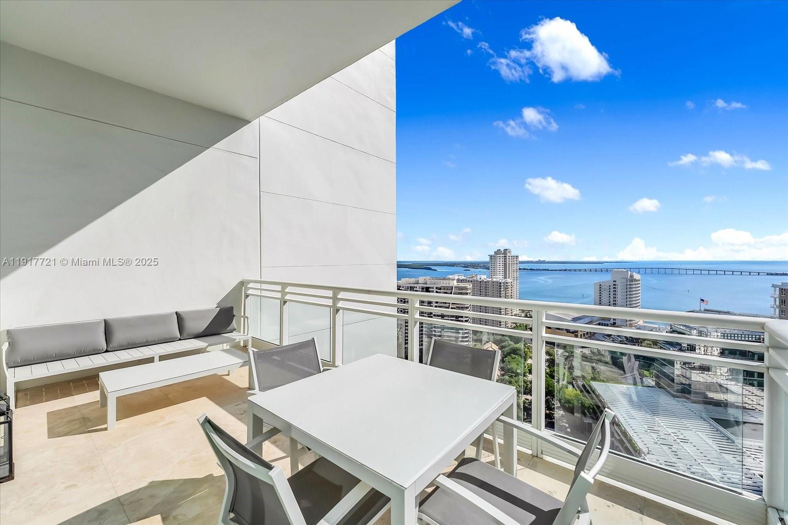 900 Brickell Key Boulevard, Unit 2304 Miami, FL 33131 - Photo 11 of 55 a view of kitchen with table and chairs