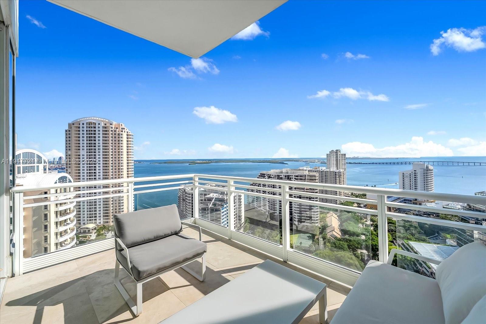 900 Brickell Key Boulevard, Unit 2304 Miami, FL 33131 - Photo 12 of 55 a view of a balcony with chairs