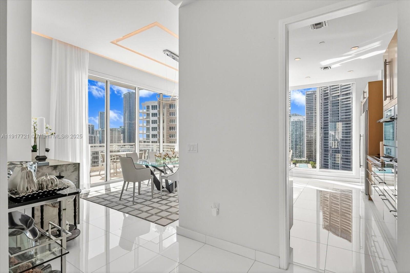 900 Brickell Key Boulevard, Unit 2304 Miami, FL 33131 - Photo 14 of 55 a living room with furniture and floor to ceiling windows