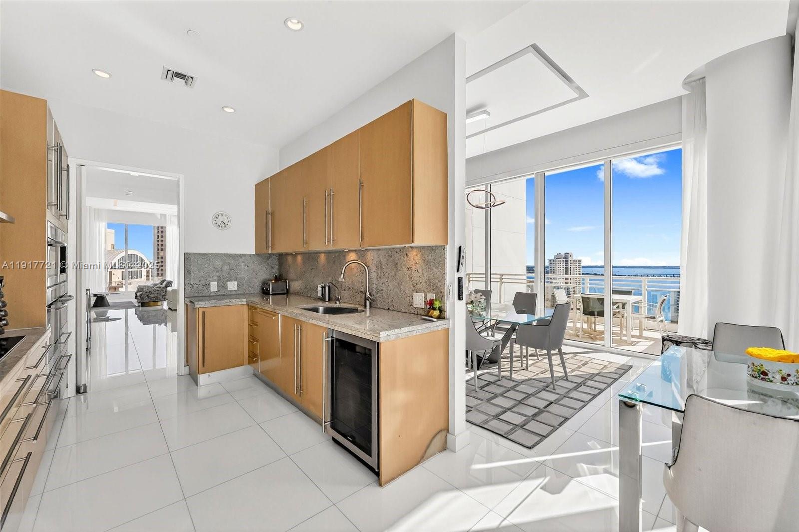 900 Brickell Key Boulevard, Unit 2304 Miami, FL 33131 - Photo 15 of 55 a kitchen with a stove a sink and a refrigerator