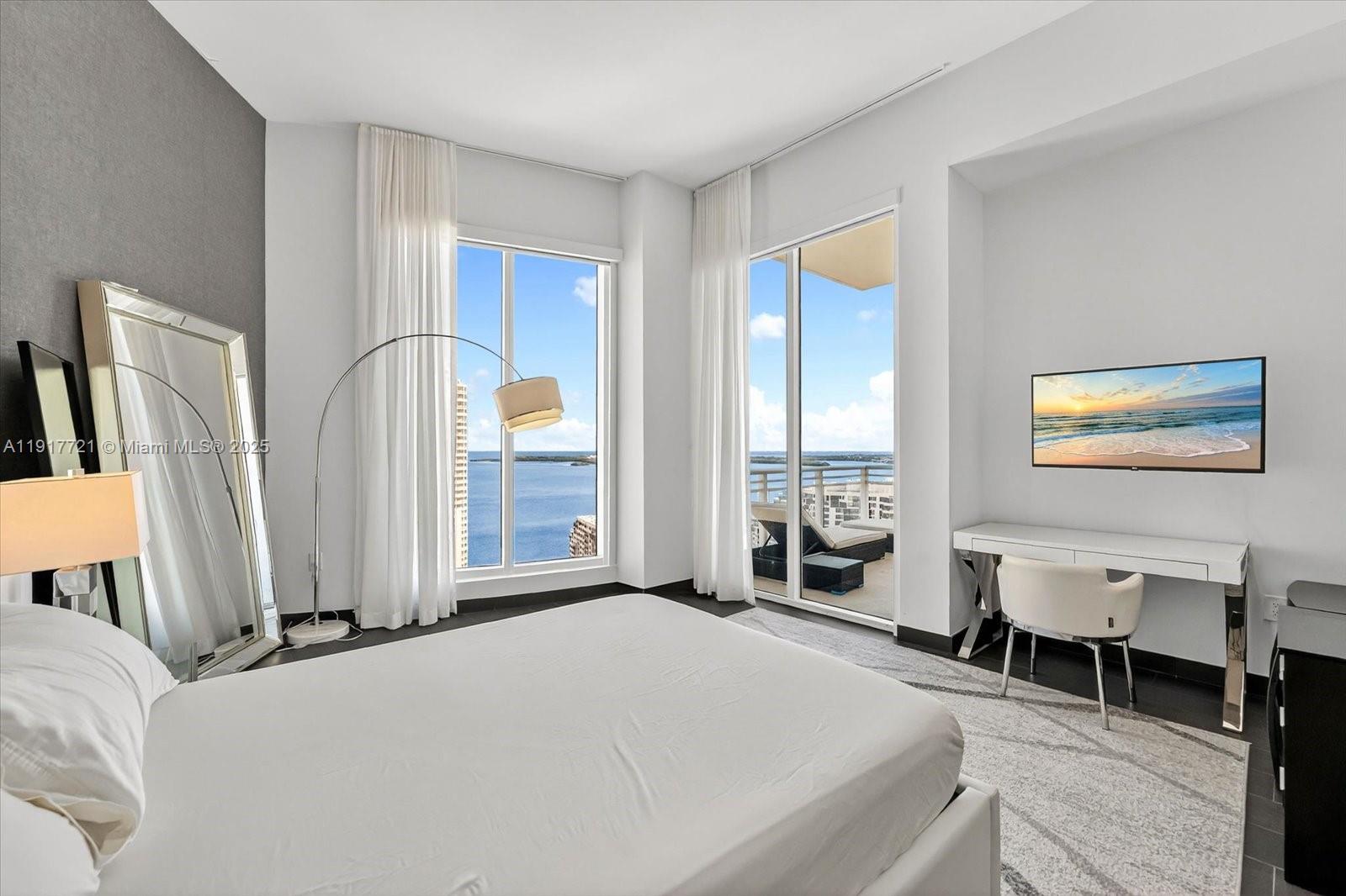 900 Brickell Key Boulevard, Unit 2304 Miami, FL 33131 - Photo 25 of 55 a bedroom with a bed and a large window