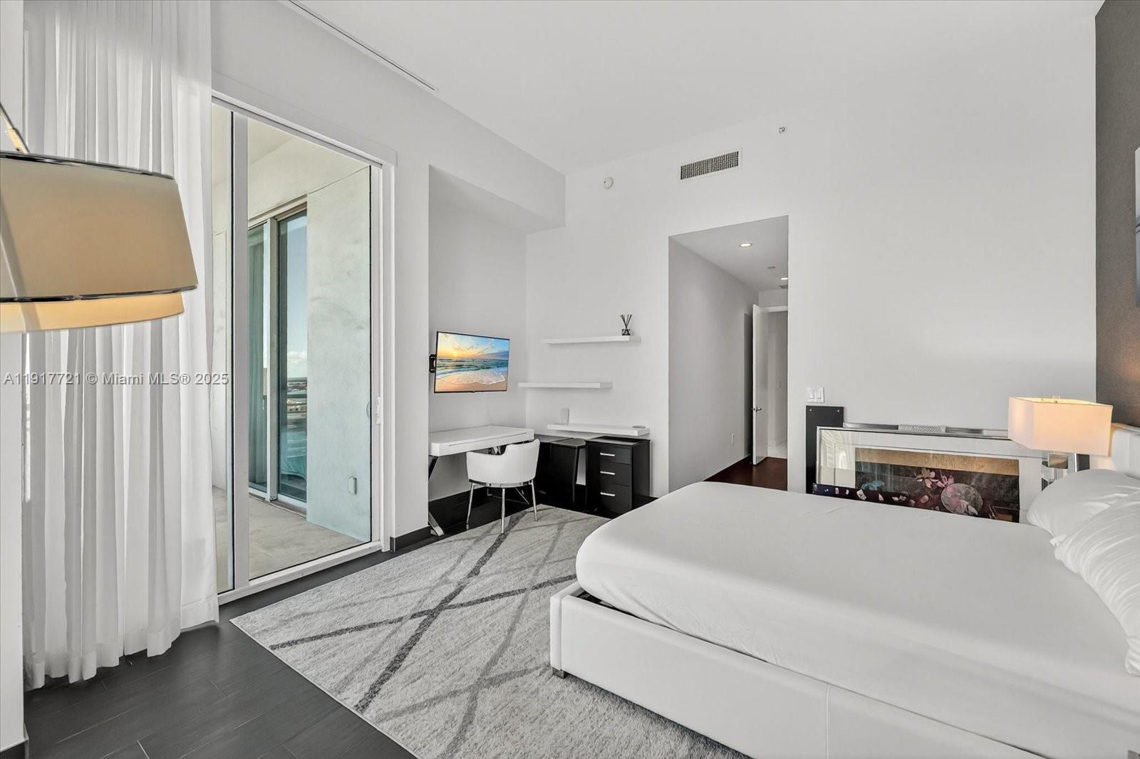 900 Brickell Key Boulevard, Unit 2304 Miami, FL 33131 - Photo 26 of 55 a bedroom with a bed a large mirror and a shower