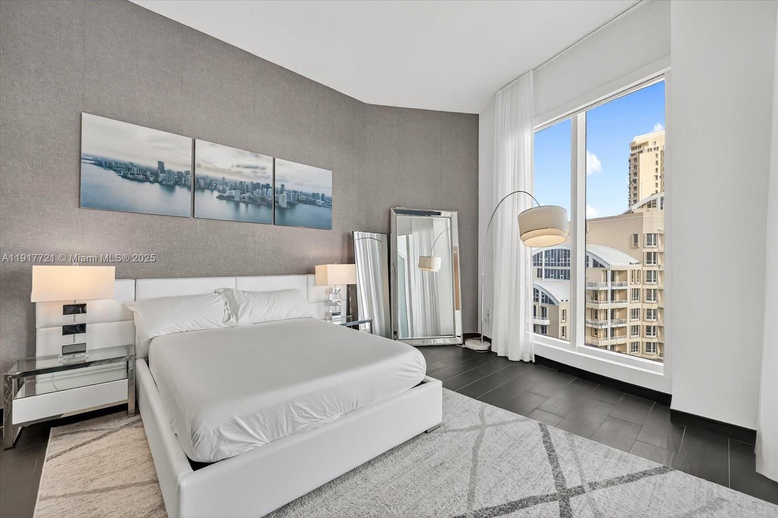 900 Brickell Key Boulevard, Unit 2304 Miami, FL 33131 - Photo 27 of 55 a bedroom with a large bed and a window