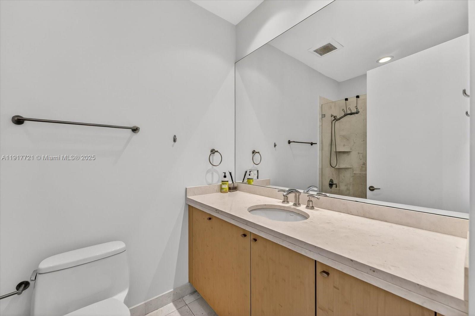 900 Brickell Key Boulevard, Unit 2304 Miami, FL 33131 - Photo 28 of 55 a bathroom with a sink a toilet and shower