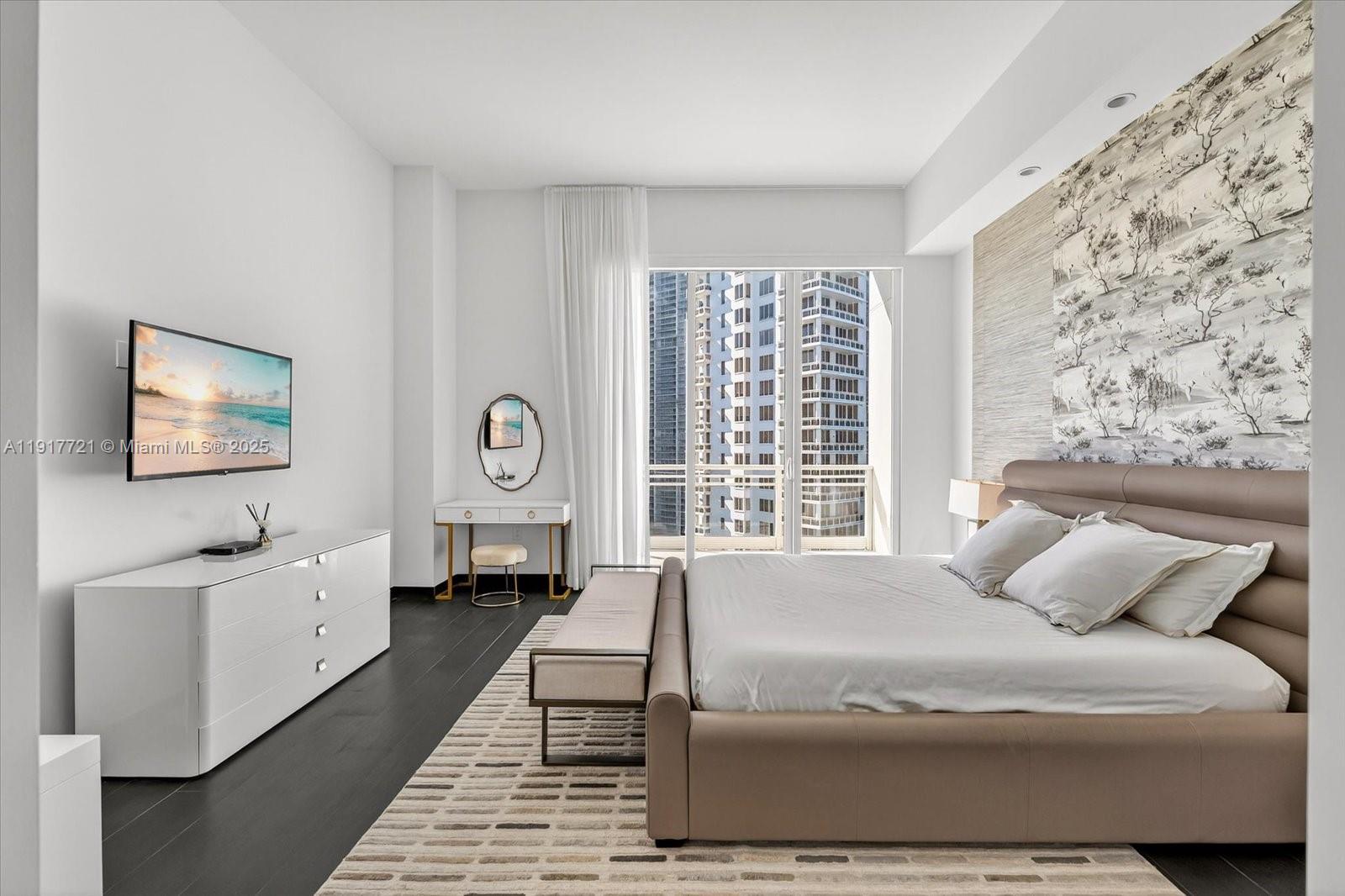 900 Brickell Key Boulevard, Unit 2304 Miami, FL 33131 - Photo 29 of 55 a spacious bedroom with a bed a mirror and a window