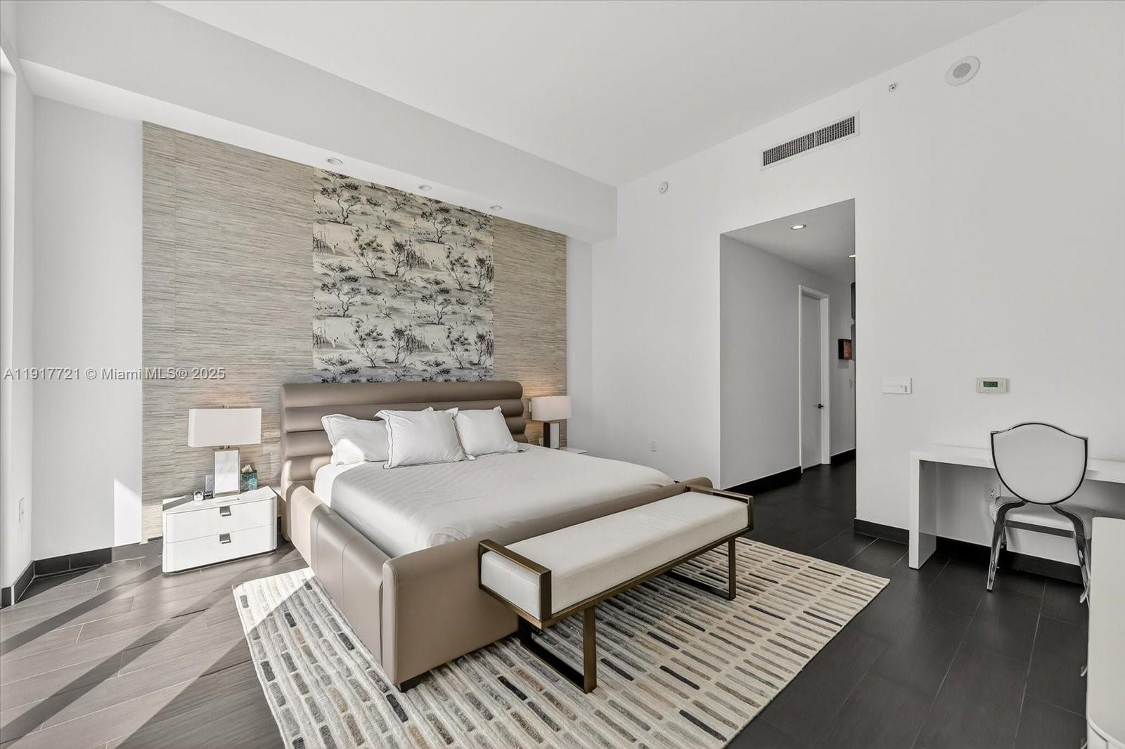 900 Brickell Key Boulevard, Unit 2304 Miami, FL 33131 - Photo 31 of 55 a living room with a couch and a table with wooden floor