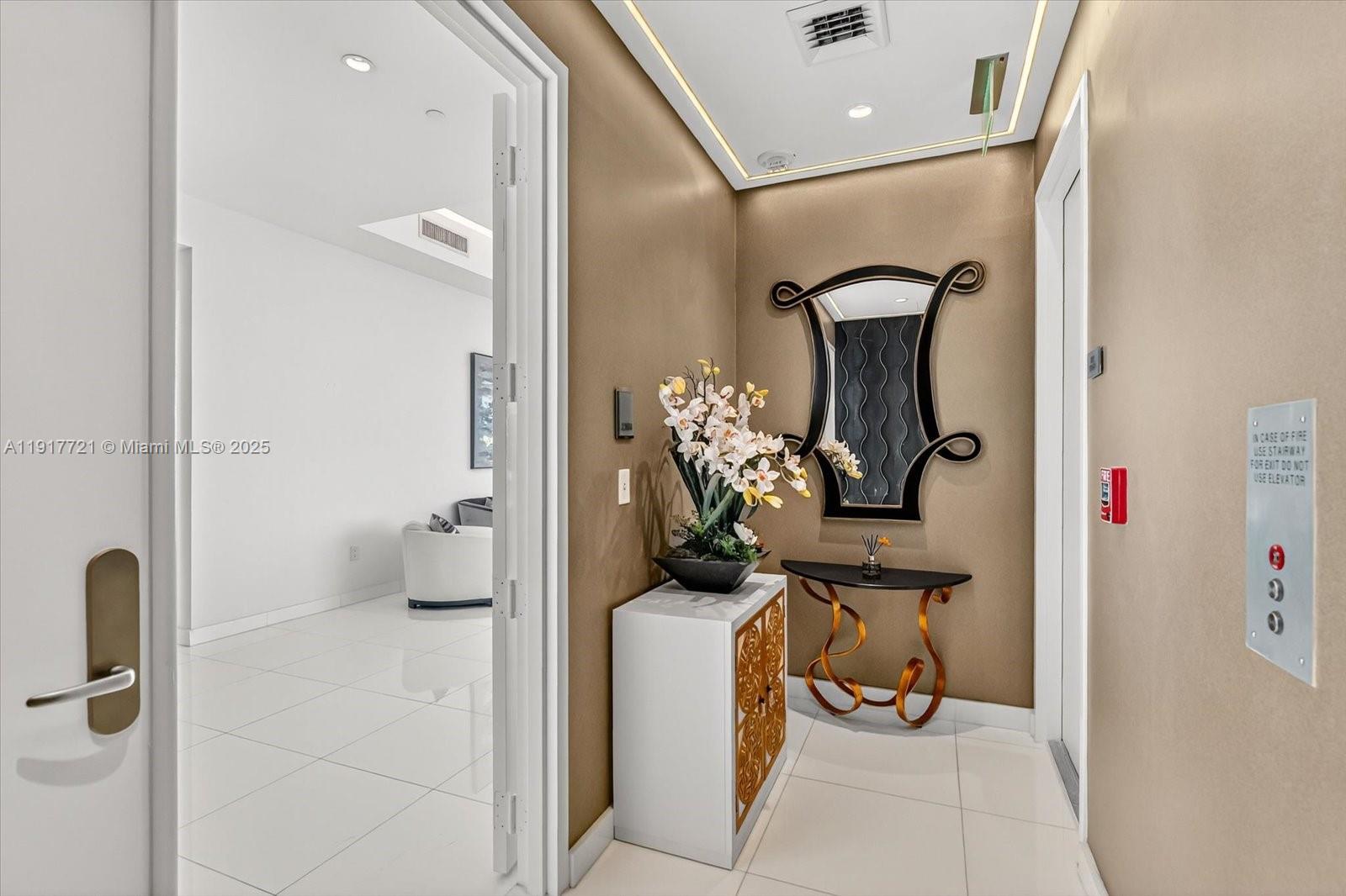 900 Brickell Key Boulevard, Unit 2304 Miami, FL 33131 - Photo 37 of 55 a bathroom with a toilet and a mirror