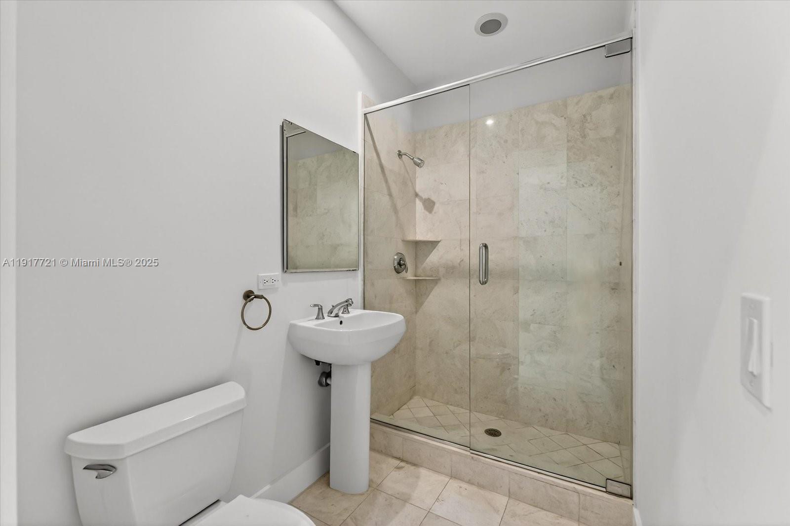 900 Brickell Key Boulevard, Unit 2304 Miami, FL 33131 - Photo 39 of 55 a bathroom with a shower a toilet and sink