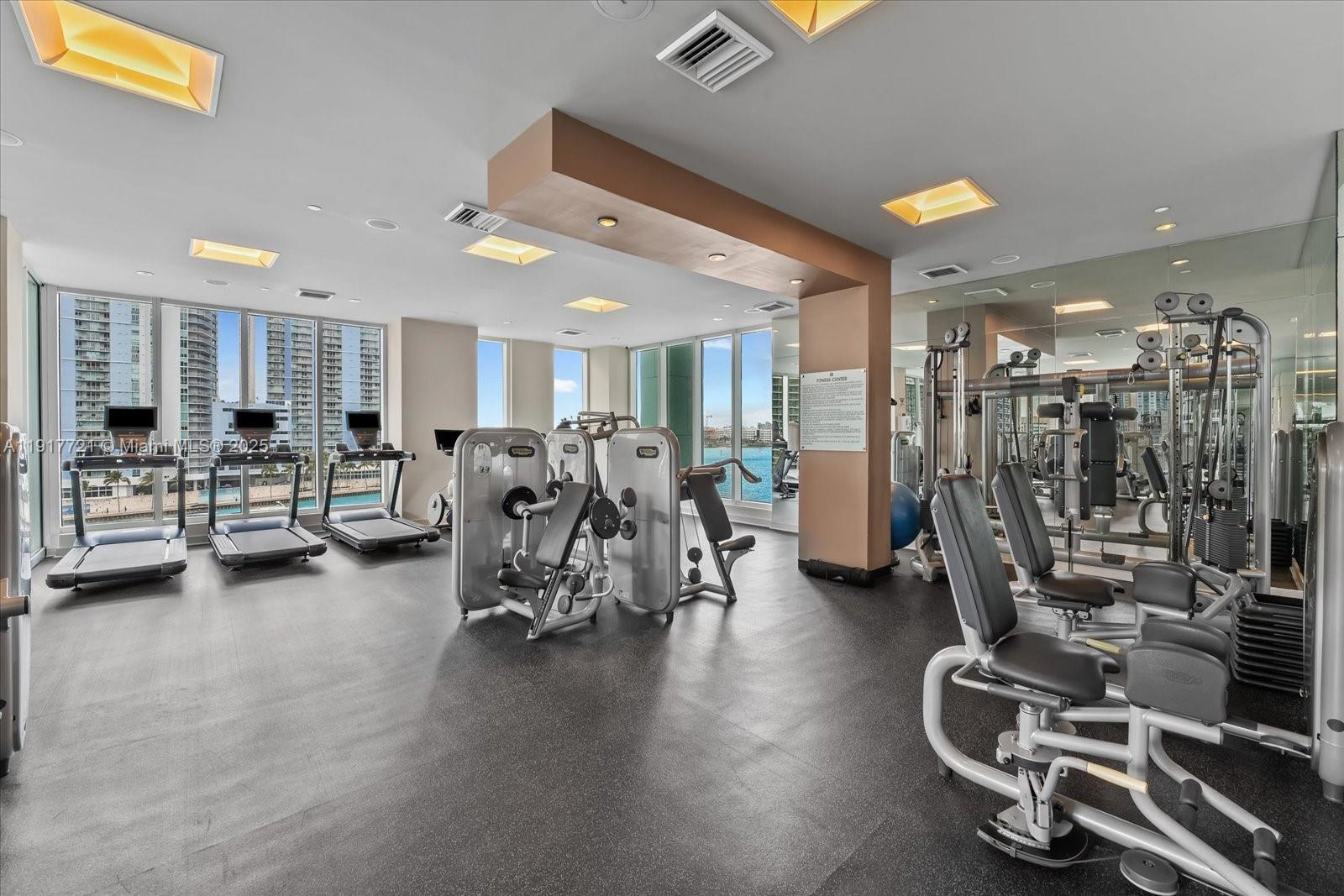 900 Brickell Key Boulevard, Unit 2304 Miami, FL 33131 - Photo 42 of 55 a view of a room with gym equipment