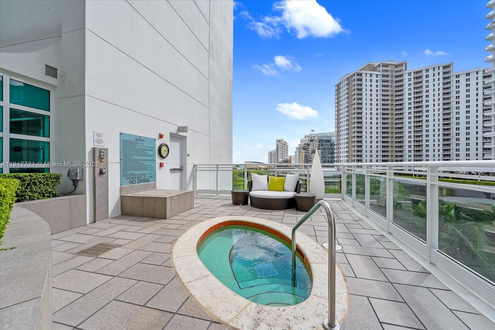 900 Brickell Key Boulevard, Unit 2304 Miami, FL 33131 - Photo 46 of 55 a view of roof deck with dining table and chairs
