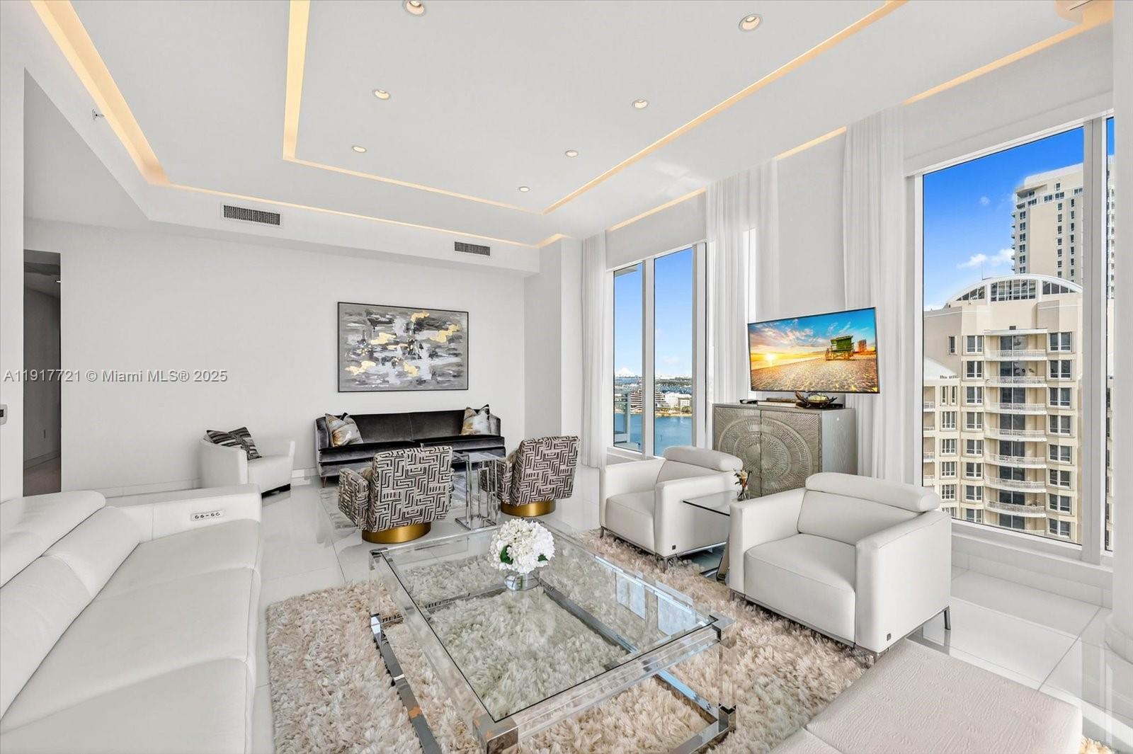 900 Brickell Key Boulevard, Unit 2304 Miami, FL 33131 - Photo 6 of 55 a living room with furniture and a large window