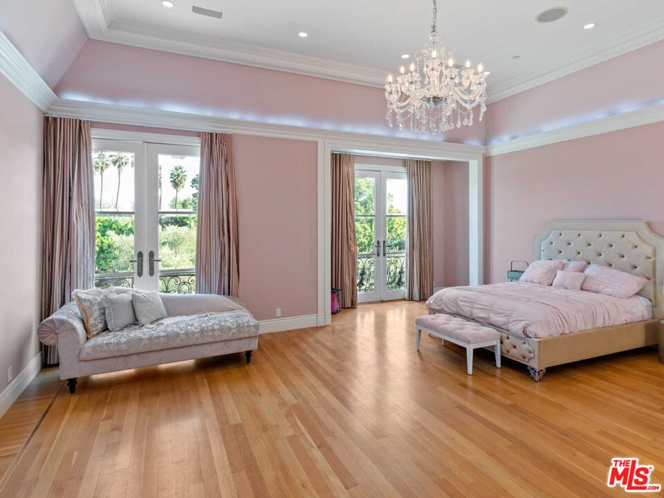 901 North Alpine Drive Beverly Hills, CA 90210 - Photo 30 of 33 a living room with furniture and a chandelier