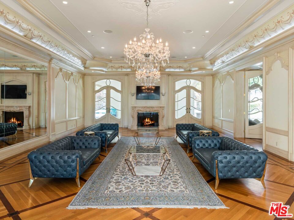 901 North Alpine Drive Beverly Hills, CA 90210 - Photo 4 of 33 a living room with furniture chandelier and a fireplace