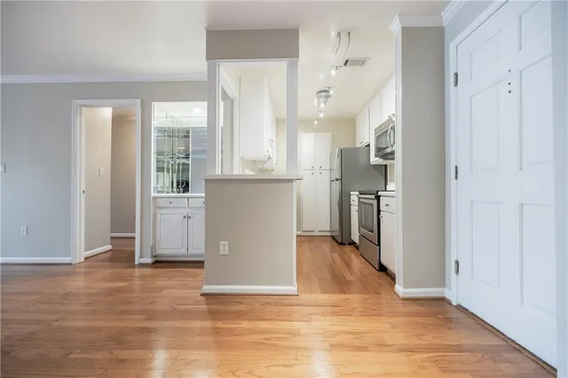 a view of kitchen with furniture and refrigerator