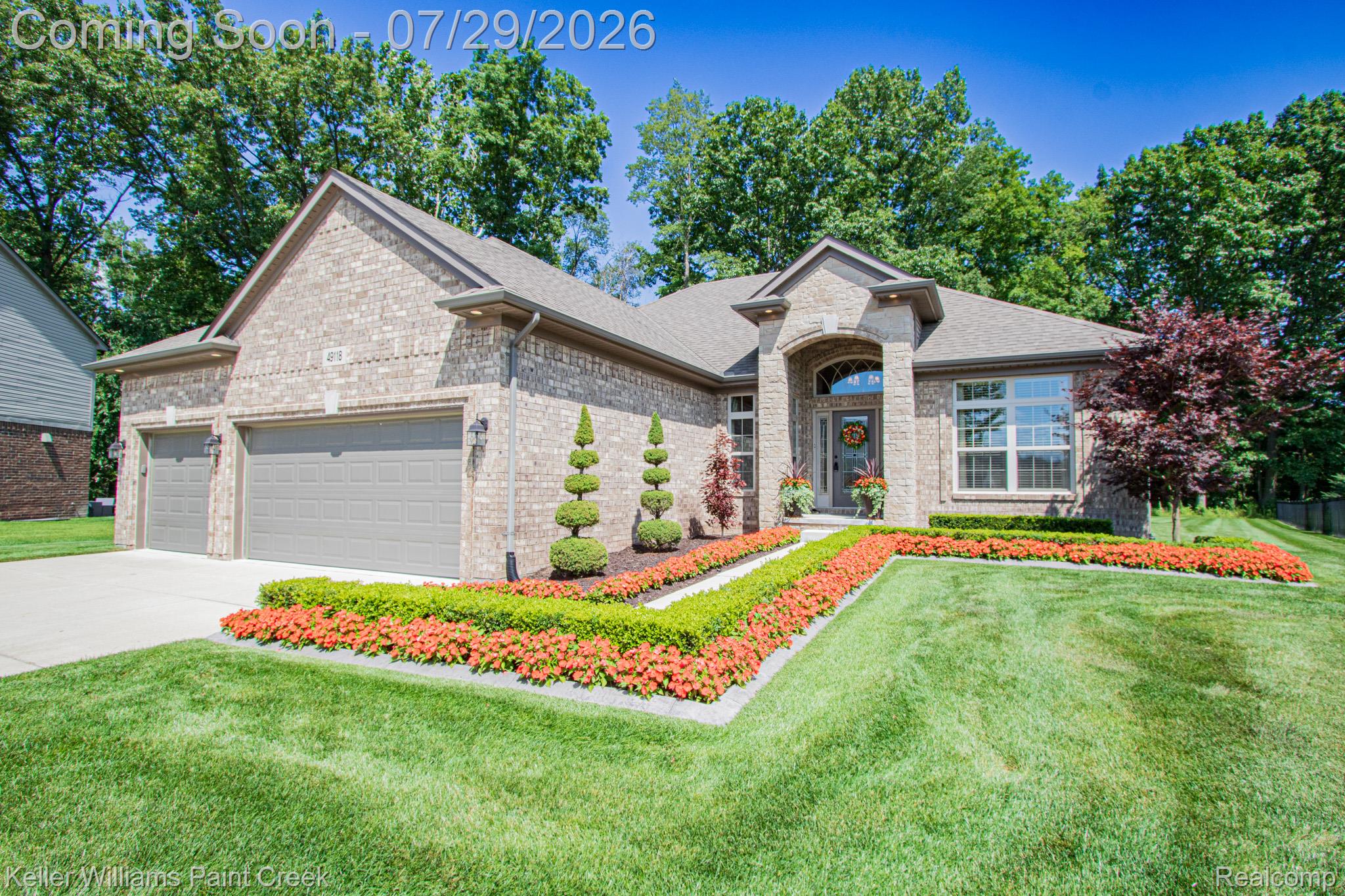 Brick exterior with a gabled roof and a two-car garage