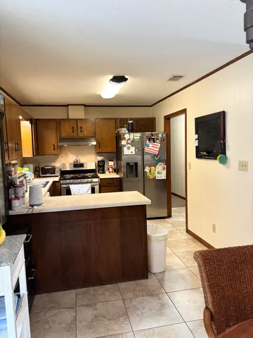 a view of a hallway with furniture and a mirror