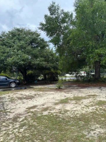 a view of a field with an trees in the background