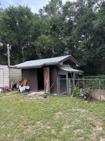 a view of a swimming pool with an outdoor seating and a yard