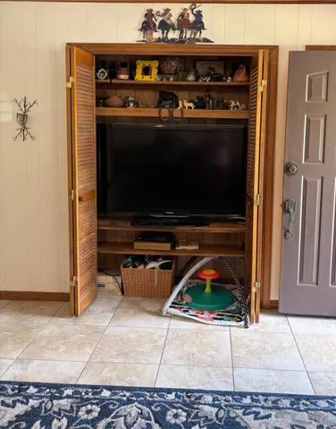 a living room with furniture a rug and a mirror