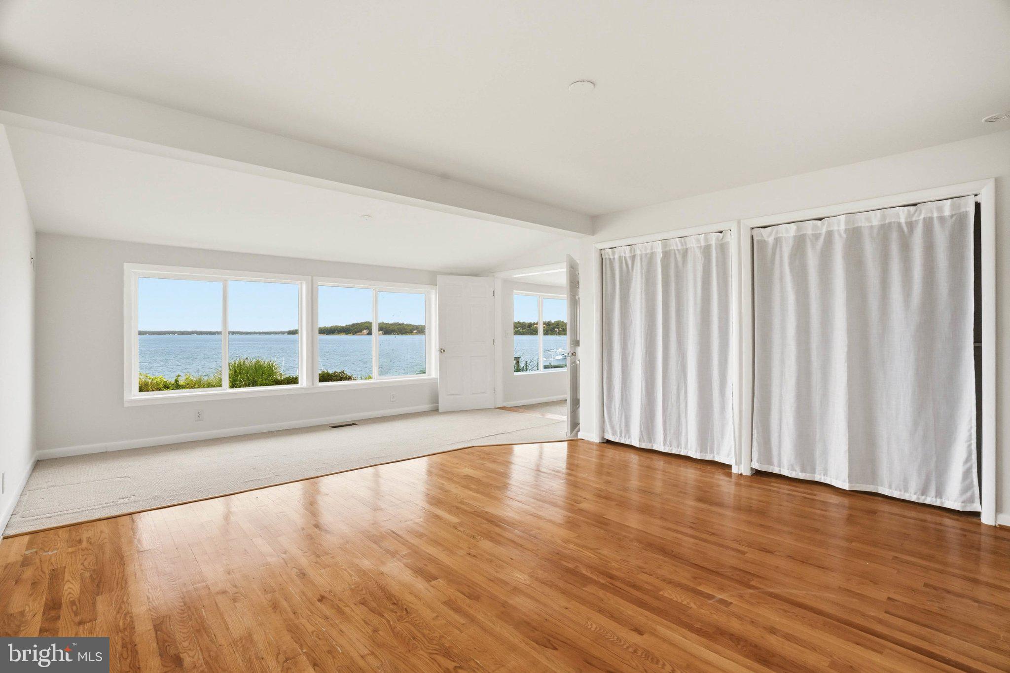 1100 River Bay Road Annapolis, MD 21409 - Photo 19 of 67 a view of an empty room with wooden floor and a window