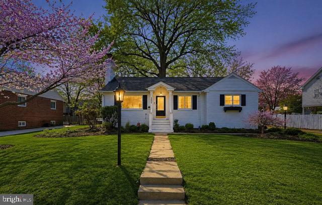 Charming home with blooming trees at dusk.